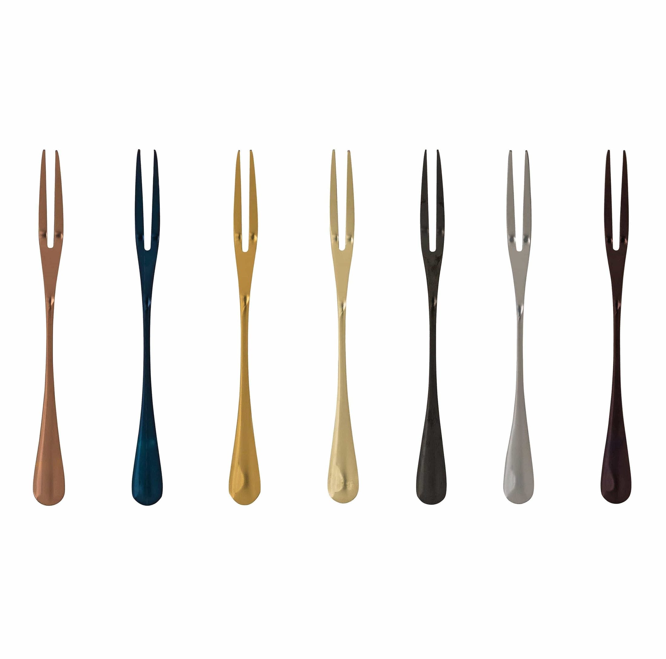 Eight fruit forks with two tines in plated stainless steel with brushed colored finishes in copper dark blue gold beige black gray and brown arranged in a row