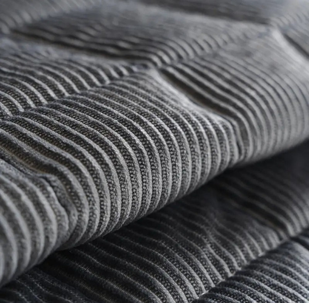 Close up of gray ribbed fabric texture from a sofa cover mat