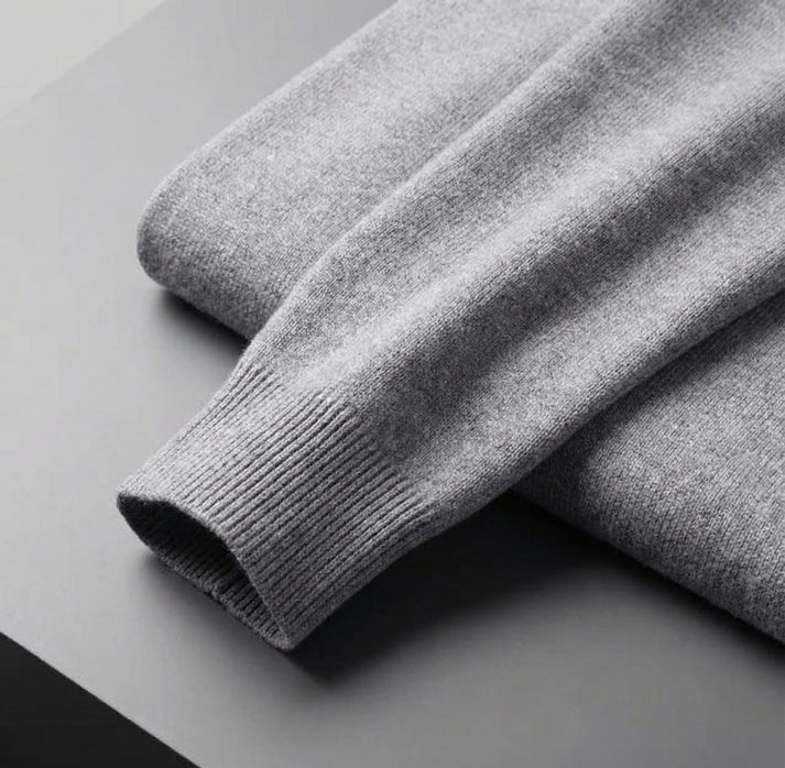 Close up of a light gray cashmere sweater sleeve with a ribbed cuff