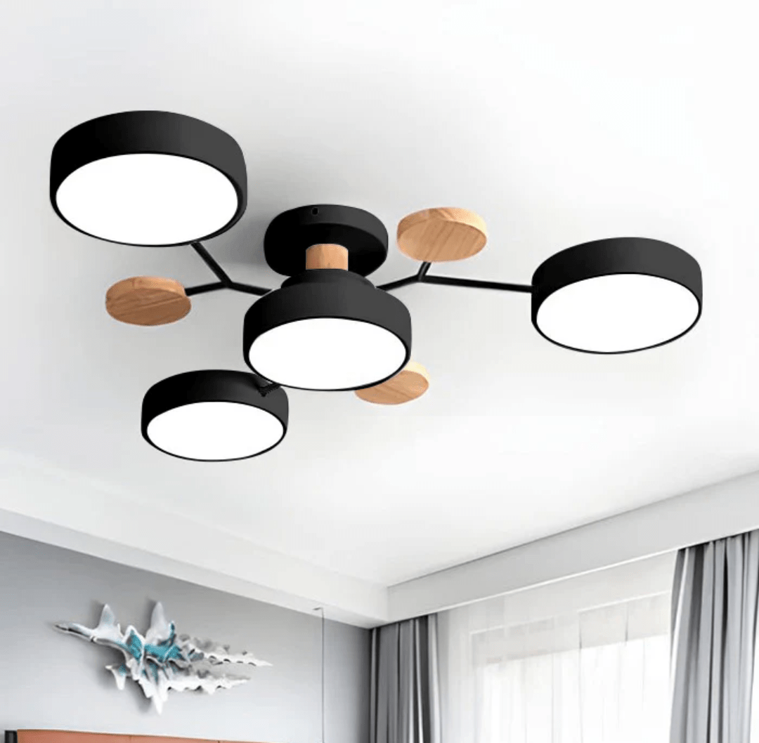 Nordhaven LED ceiling light with iron frame and wood accents featuring several round black metal light heads with white diffusers mounted on slender arms