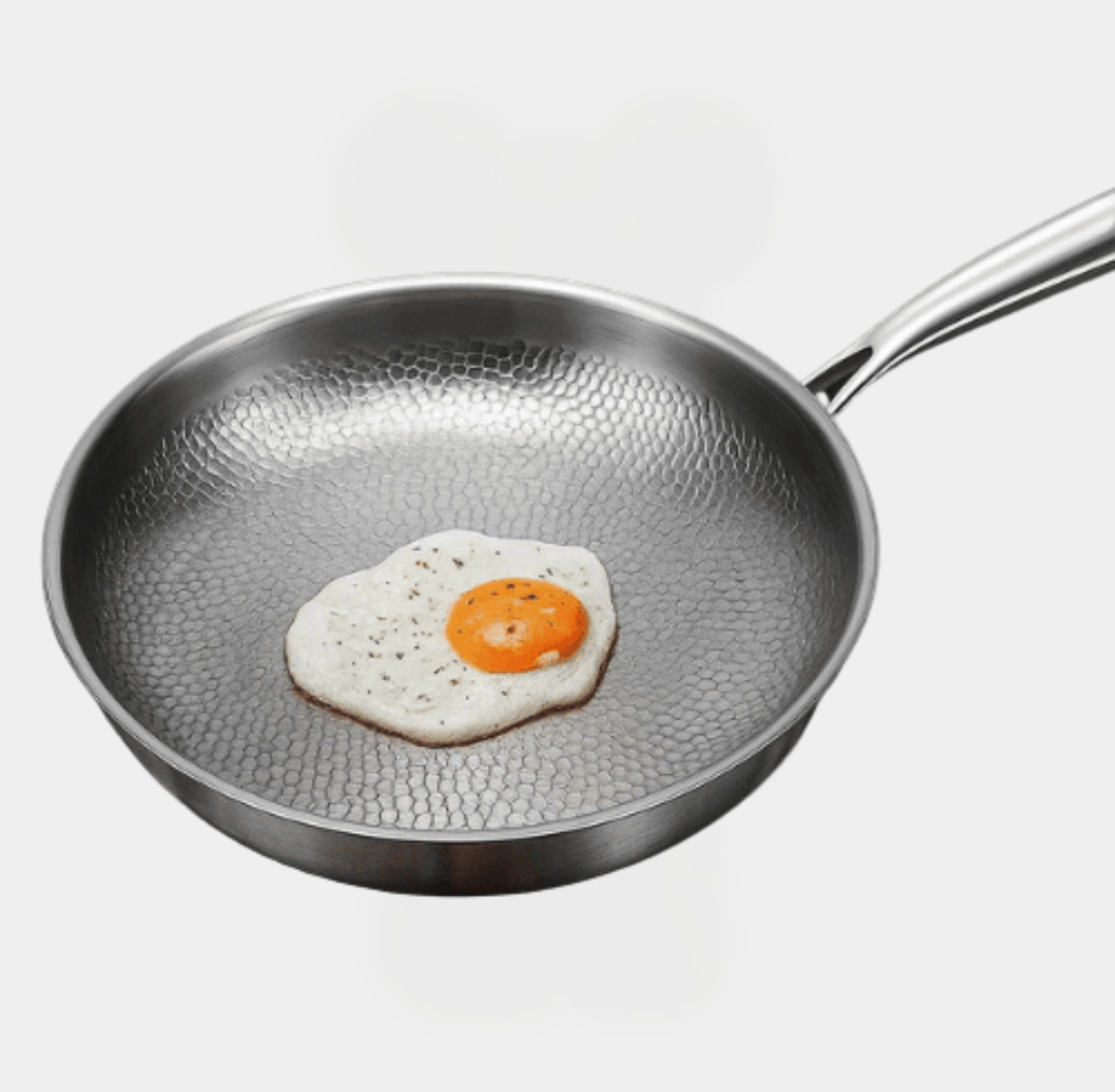 Auron pure titanium frying pan with textured natural nonstick surface cooking a sunny side up egg