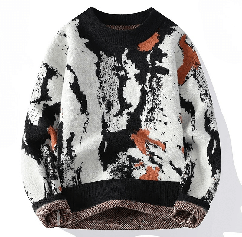 Knitted sweater with abstract black white and orange pattern, cream base, puff sleeves, and ribbed black neckline