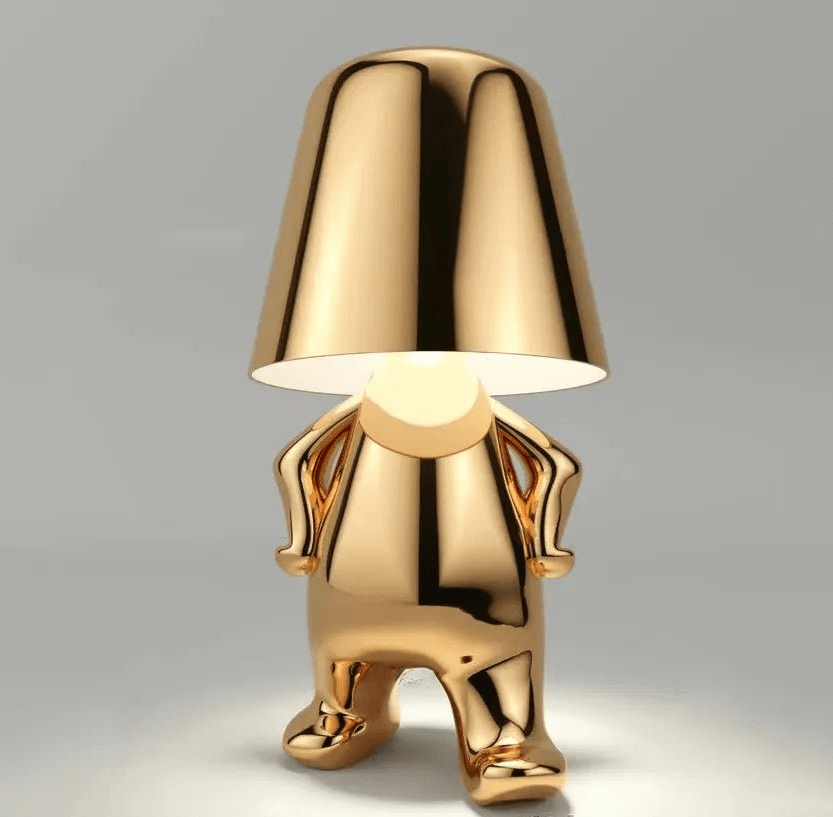 Gold aluminum table lamp in the shape of a dog with a frosted glass shade on its head