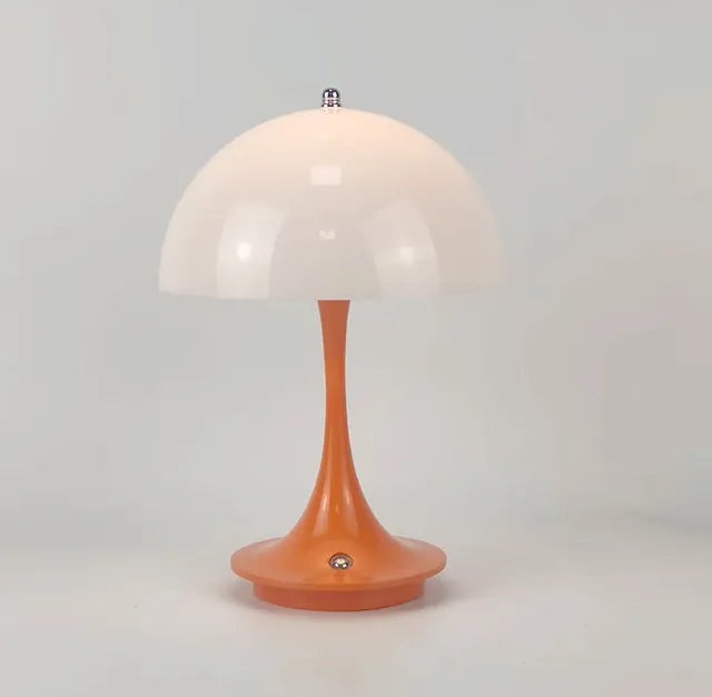 Orange base table lamp with a curved stem and a white dome lampshade