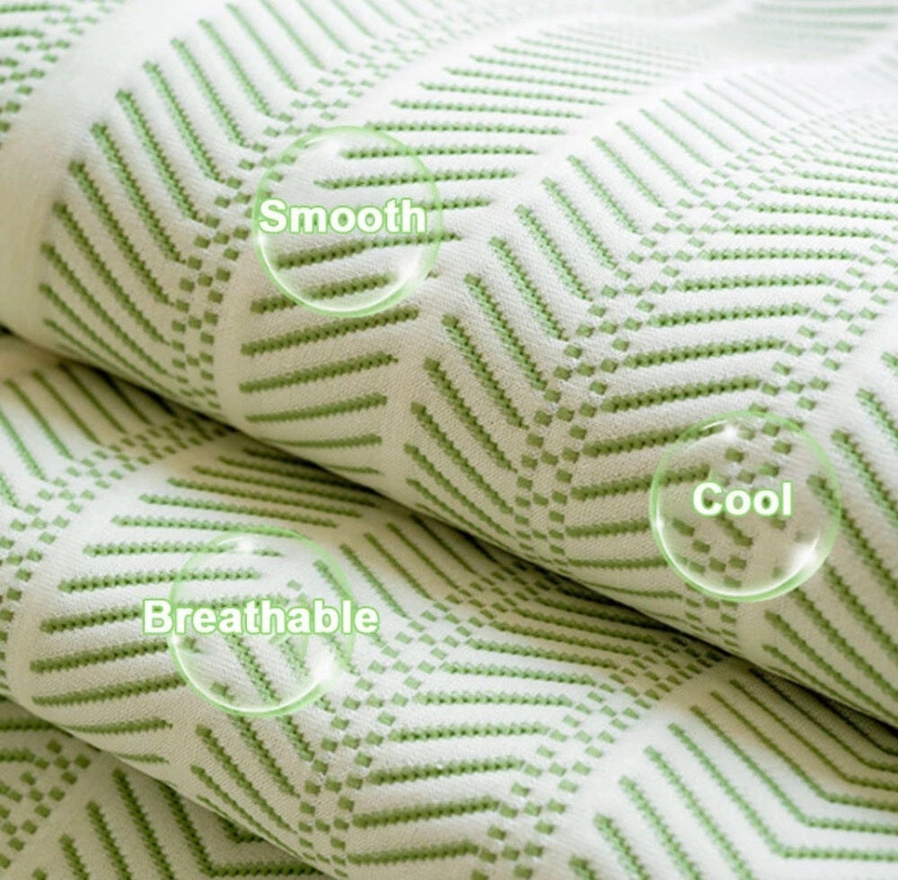 Close up of white sofa cover fabric with a green zigzag pattern and circular labels reading Smooth breathable cool