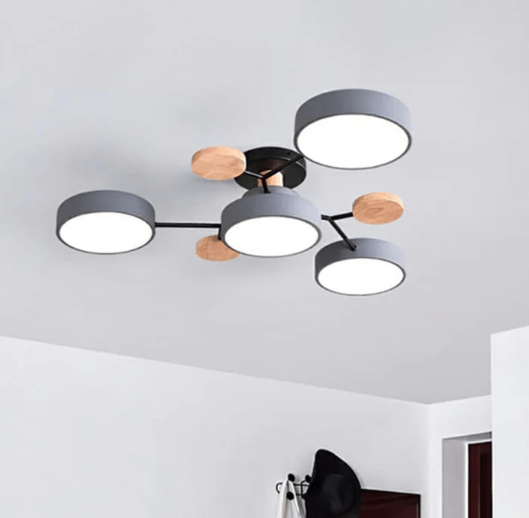 Nordhaven LED ceiling light with multiple round grey shades connected by black arms and wooden accents on the ceiling