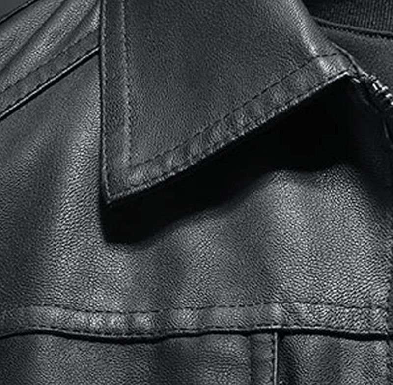 Close up of a black leather biker jacket with a lapel collar and visible zipper hardware