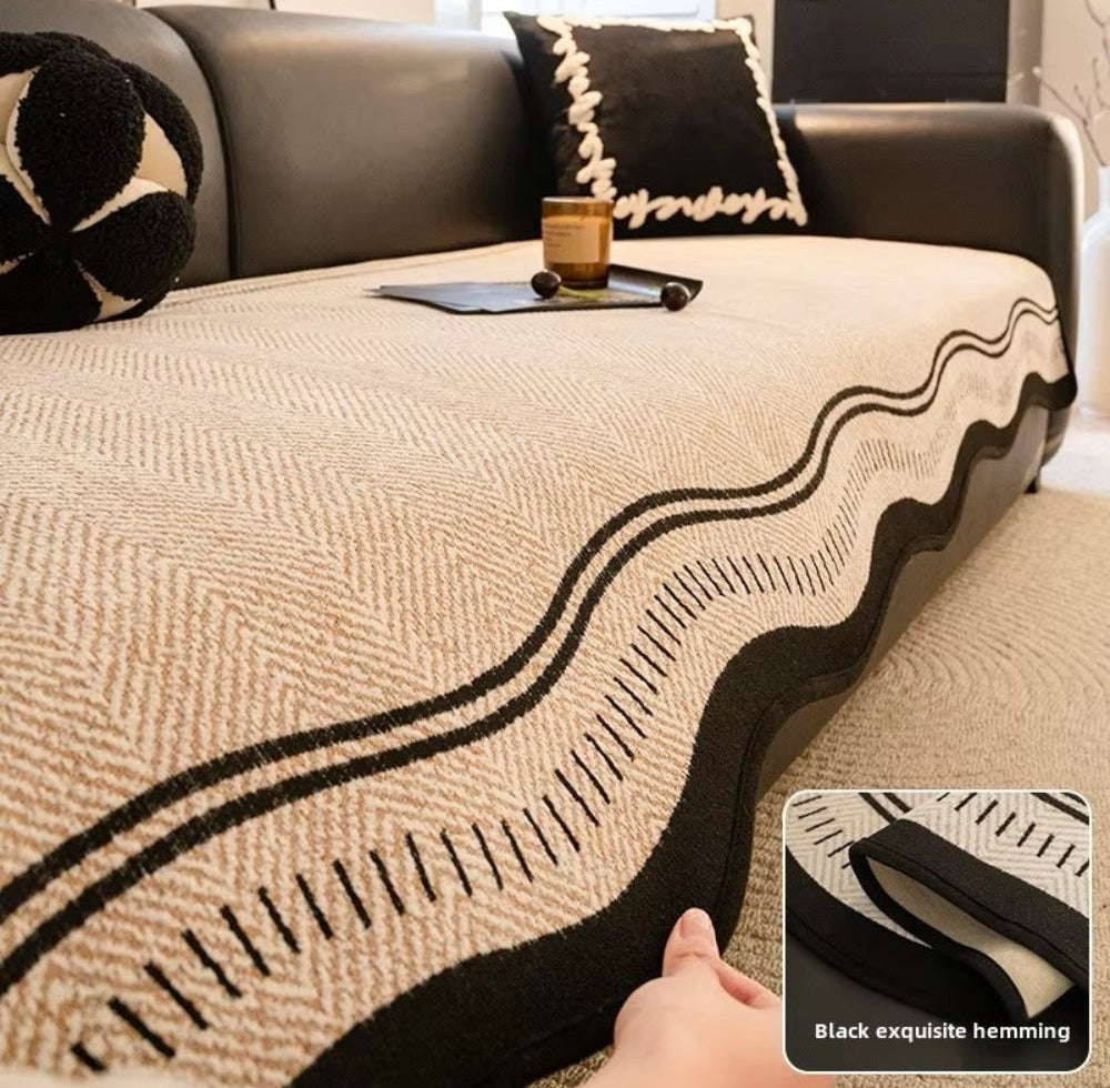 Beige microfiber sofa cover with a black wavy edge design on a sofa with a black and white pillow and an inset showing black exquisite hemming