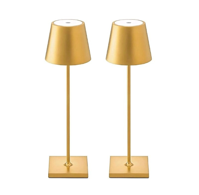 Two gold table lamps with square bases, tall slender stems, and gold conical lampshades