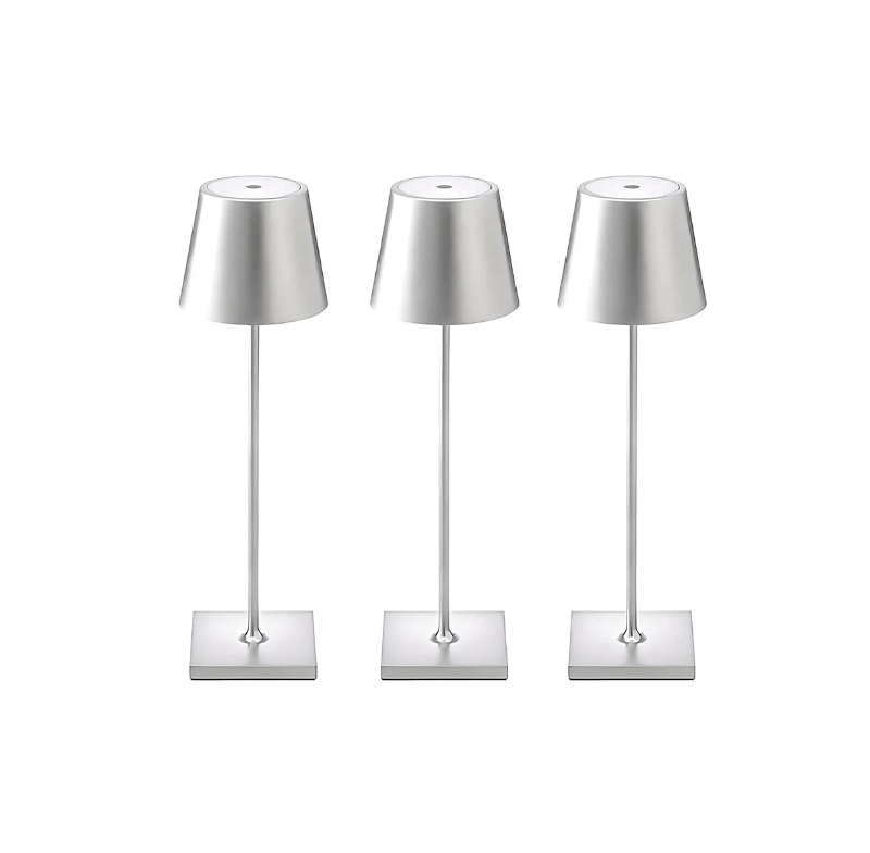 Three silver cordless table lamps with conical metal shades and square bases.